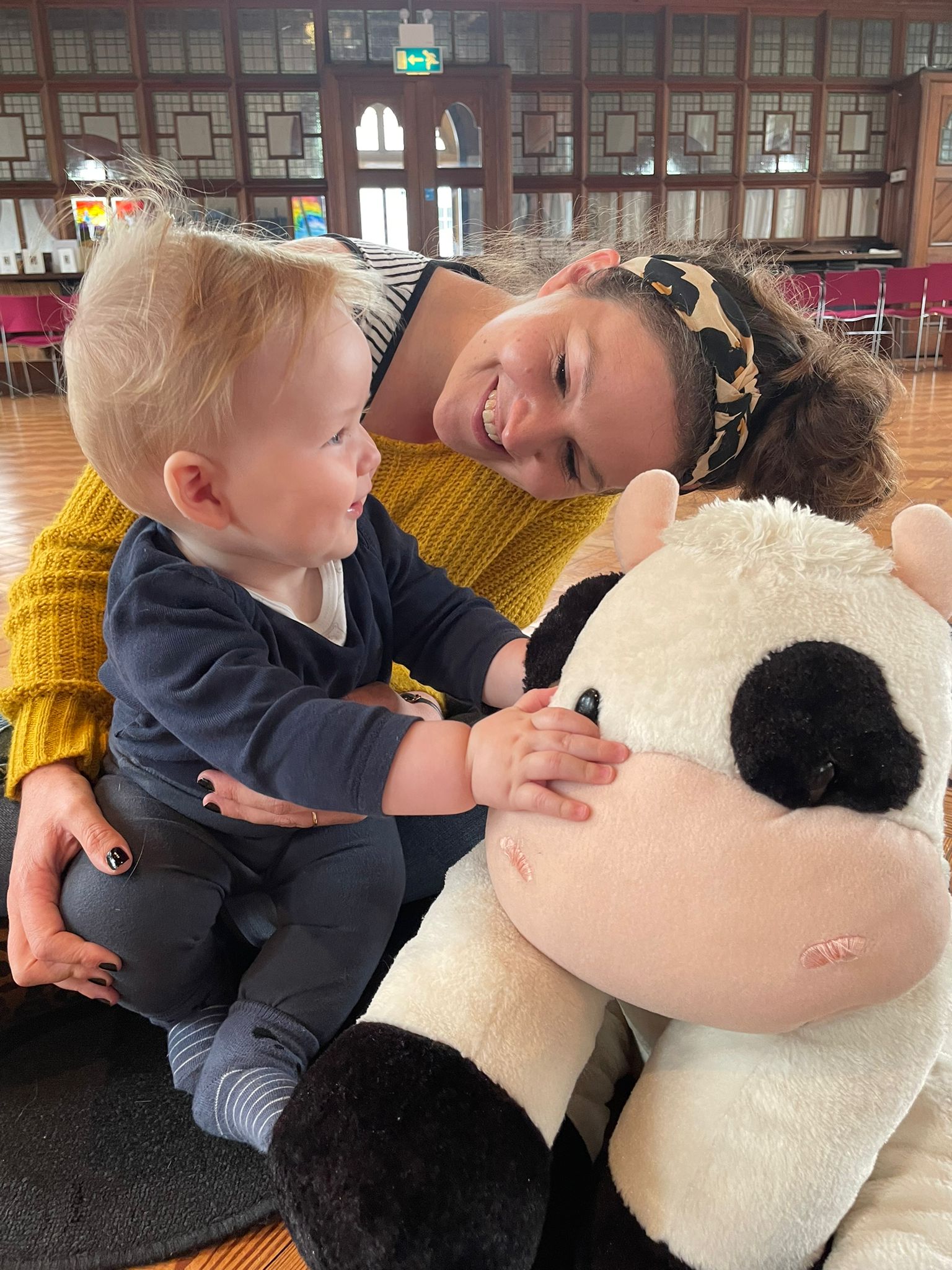 Smiling parent and child with Molly Moocow